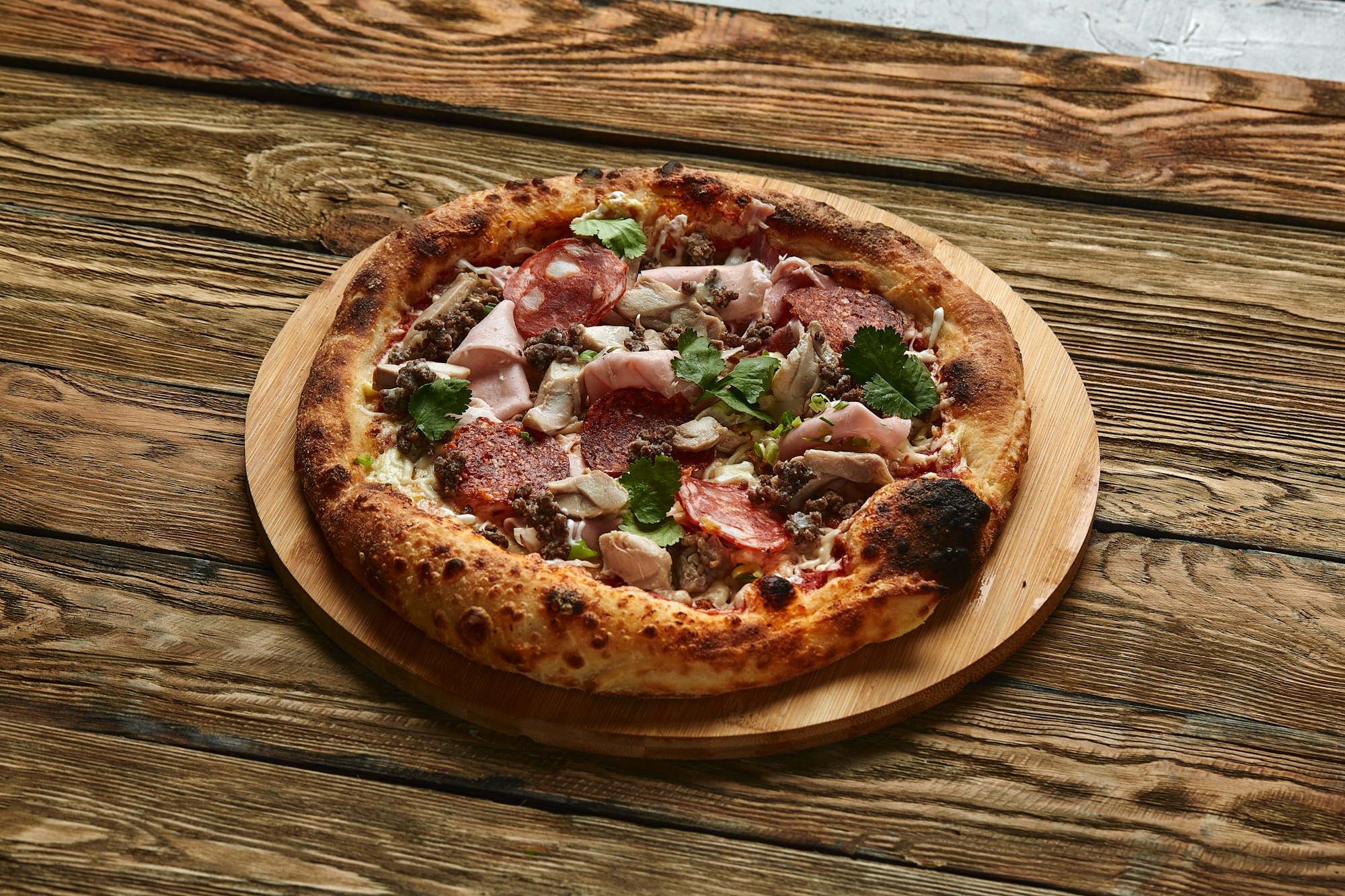 Meat Italian pizza with roast beef, steak slices, melted cheese, with olive slices and cheddar